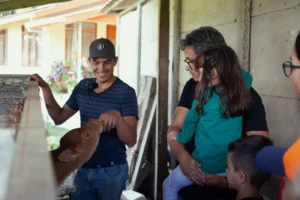 Producer explaining cheese-making to father and daughter